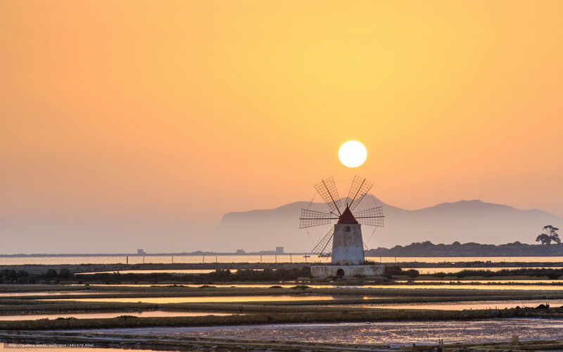 Sunset over salt pans and windmill