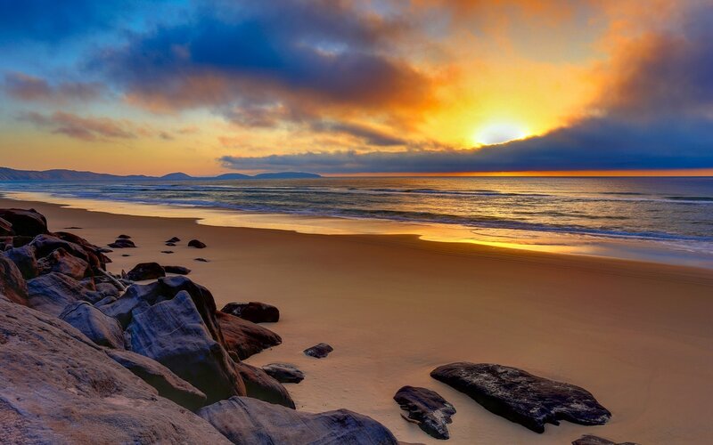 Sunset over Sandy Beach — Orange, Dramatic, Photograph, Rocks