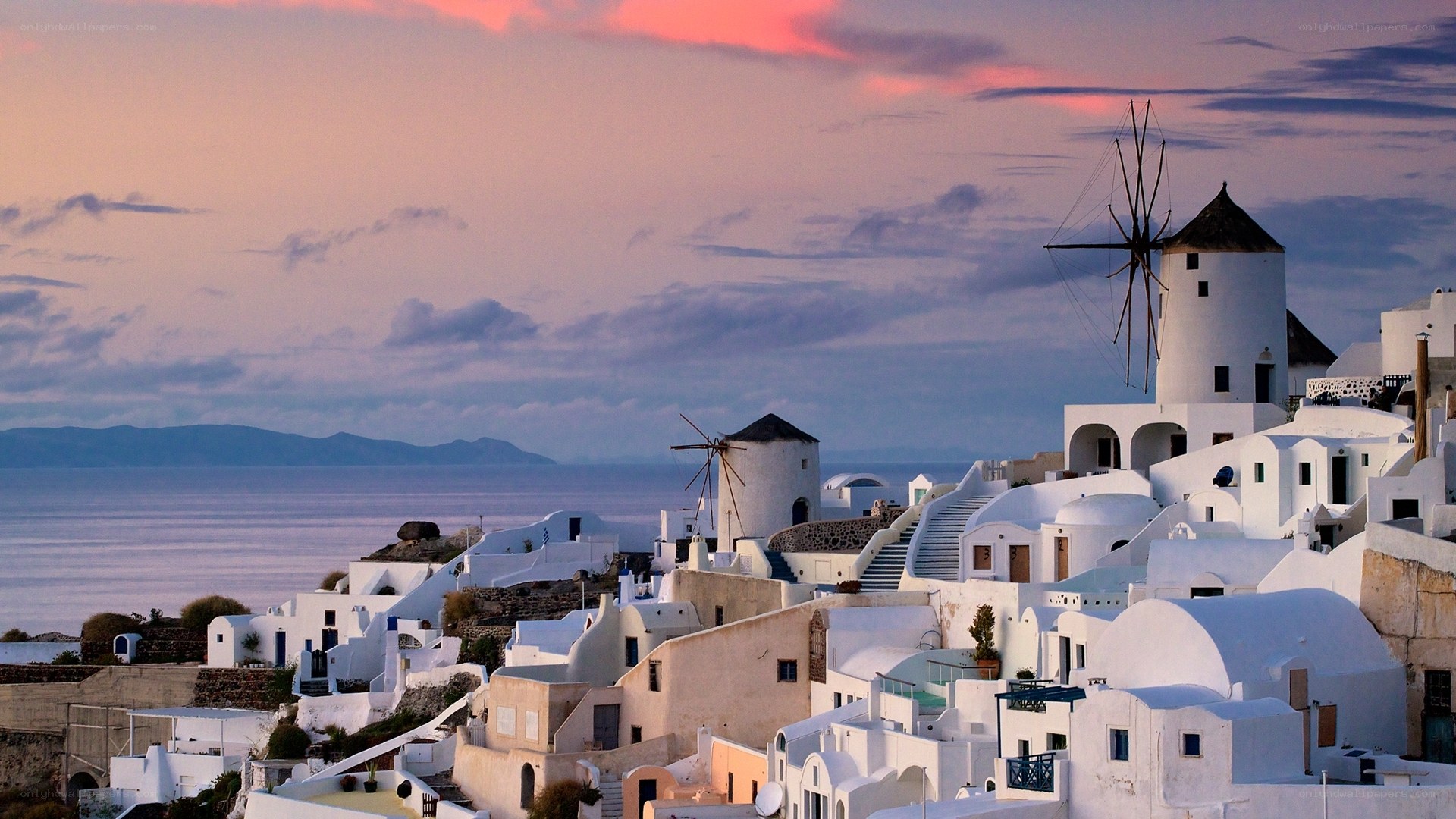 Sunset over Santorini windmills