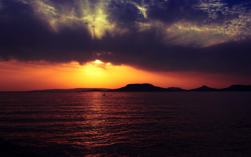 Sunset over Sea — Orange, Dramatic, Photograph, Clouds, Islands