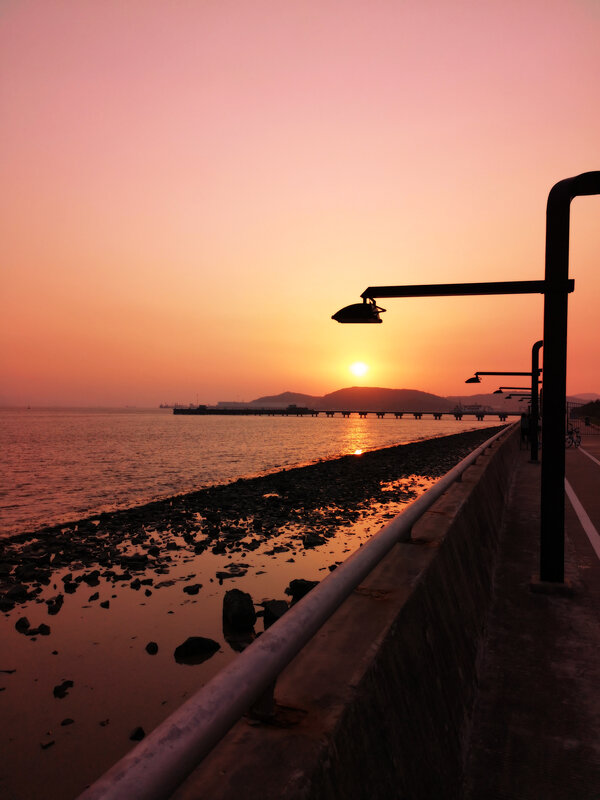 Sunset over Sea — Orange, Serene, Photograph, Pier, Streetlights