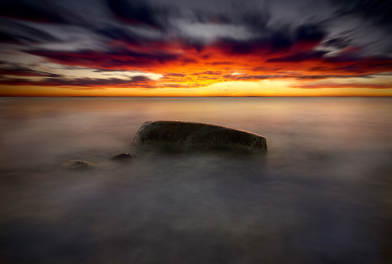Sunset over sea with rock