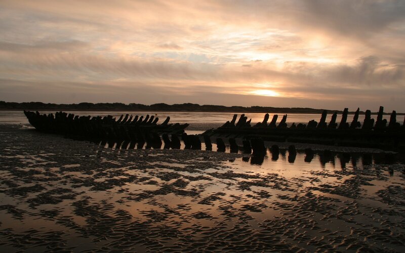 Sunset over shipwreck remains