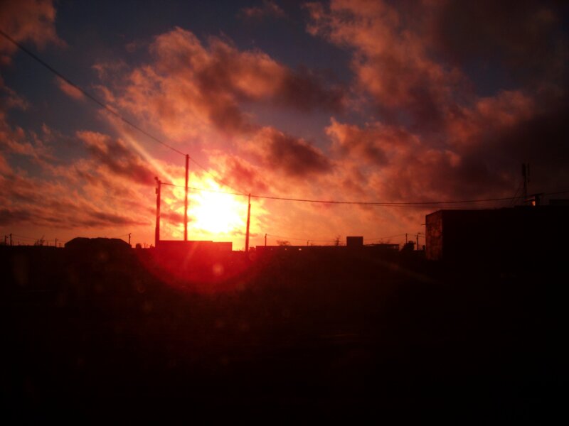 sunset over silhouetted buildings