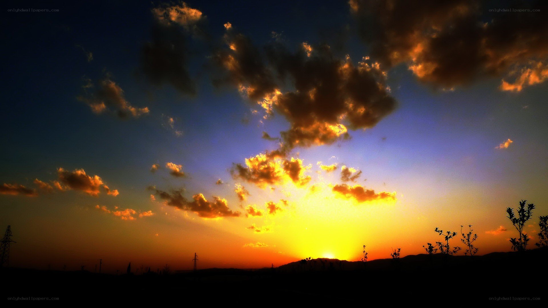 sunset over silhouetted hills