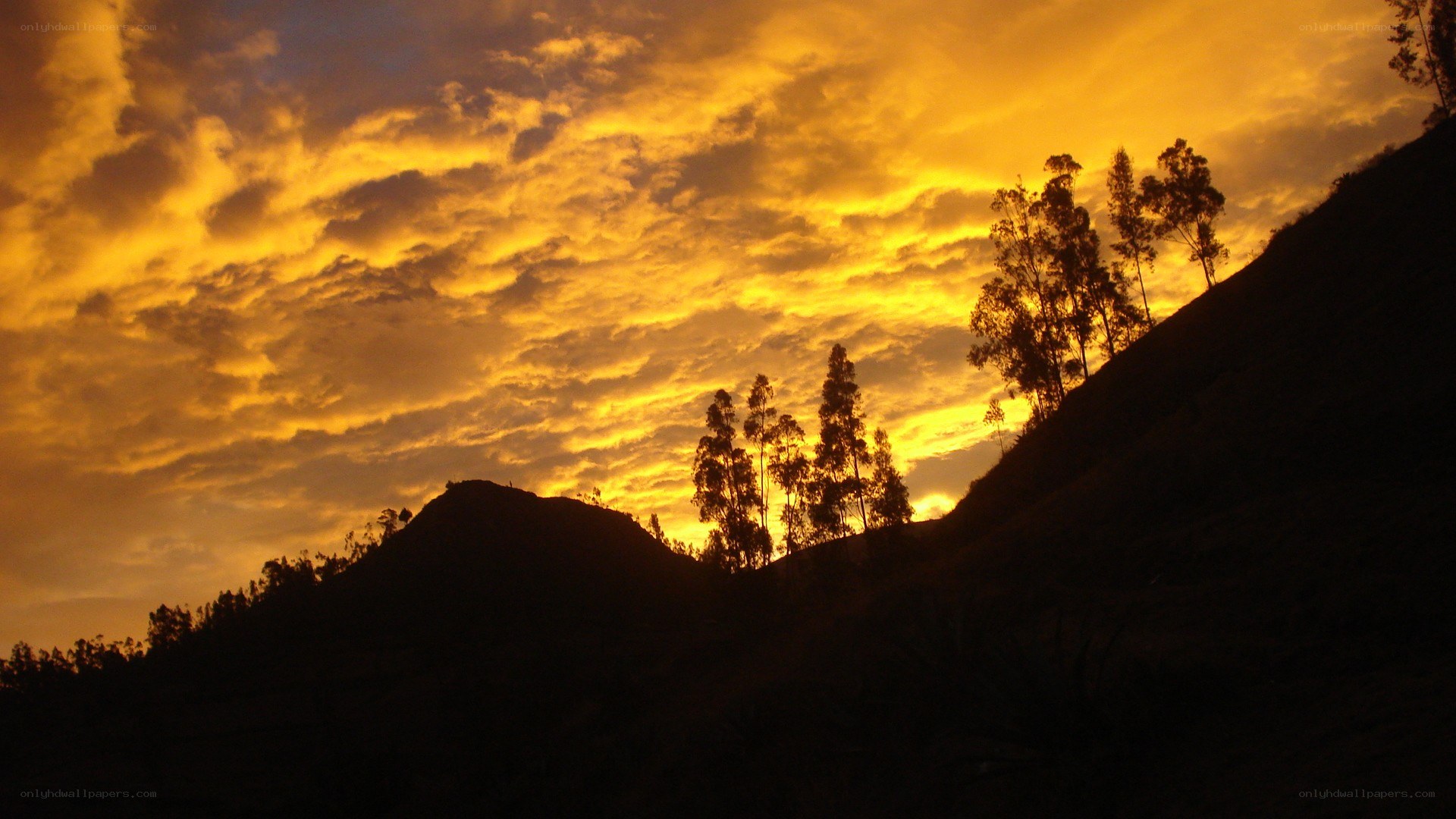 sunset over silhouetted hills