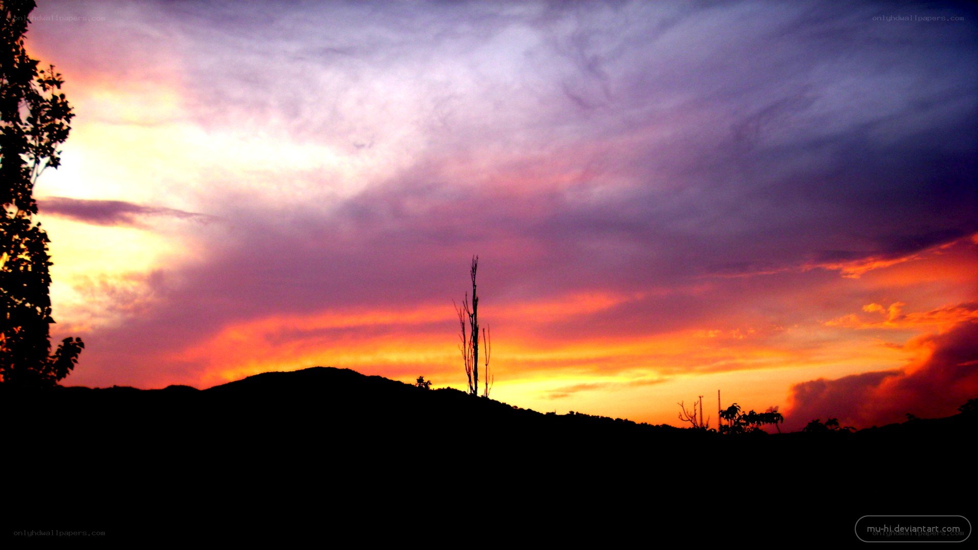 sunset over silhouetted hills