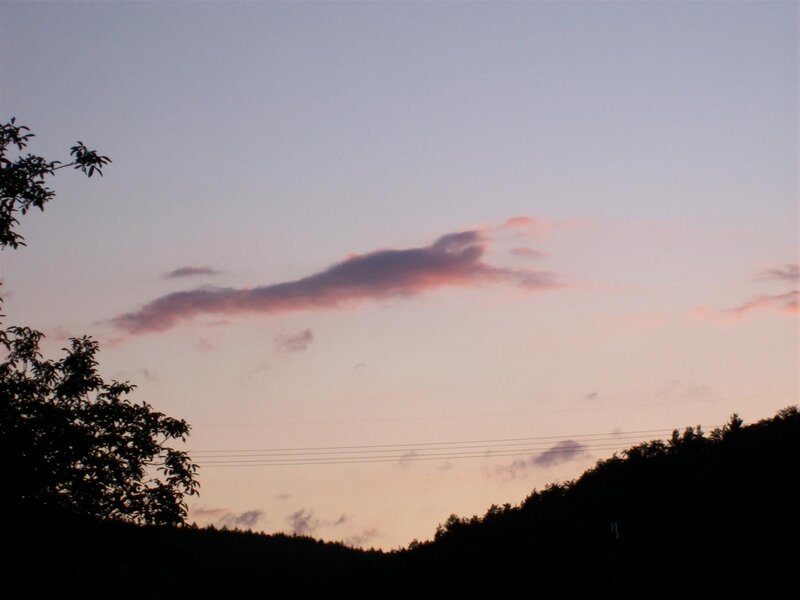 sunset over silhouetted hills