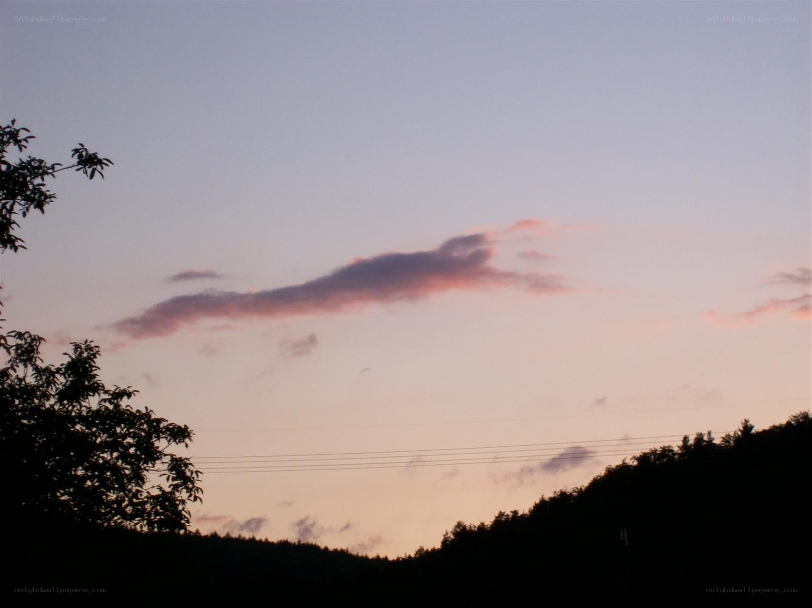 sunset over silhouetted hills