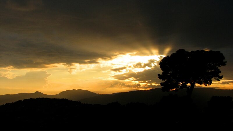 sunset over silhouetted hills