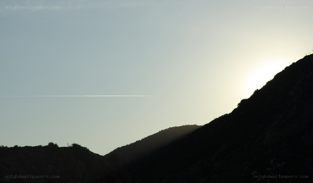 Sunset over silhouetted hills