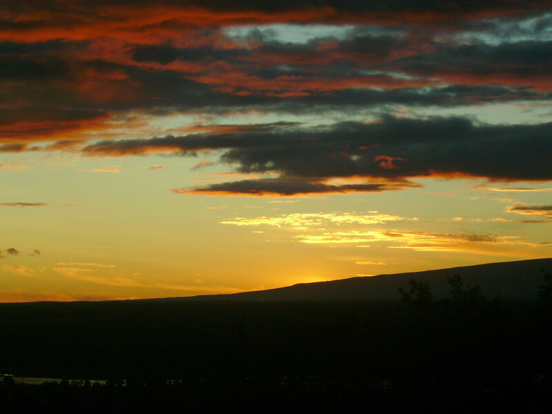 Sunset over silhouetted hills