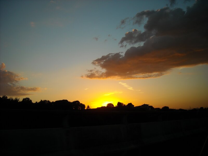 sunset over silhouetted landscape
