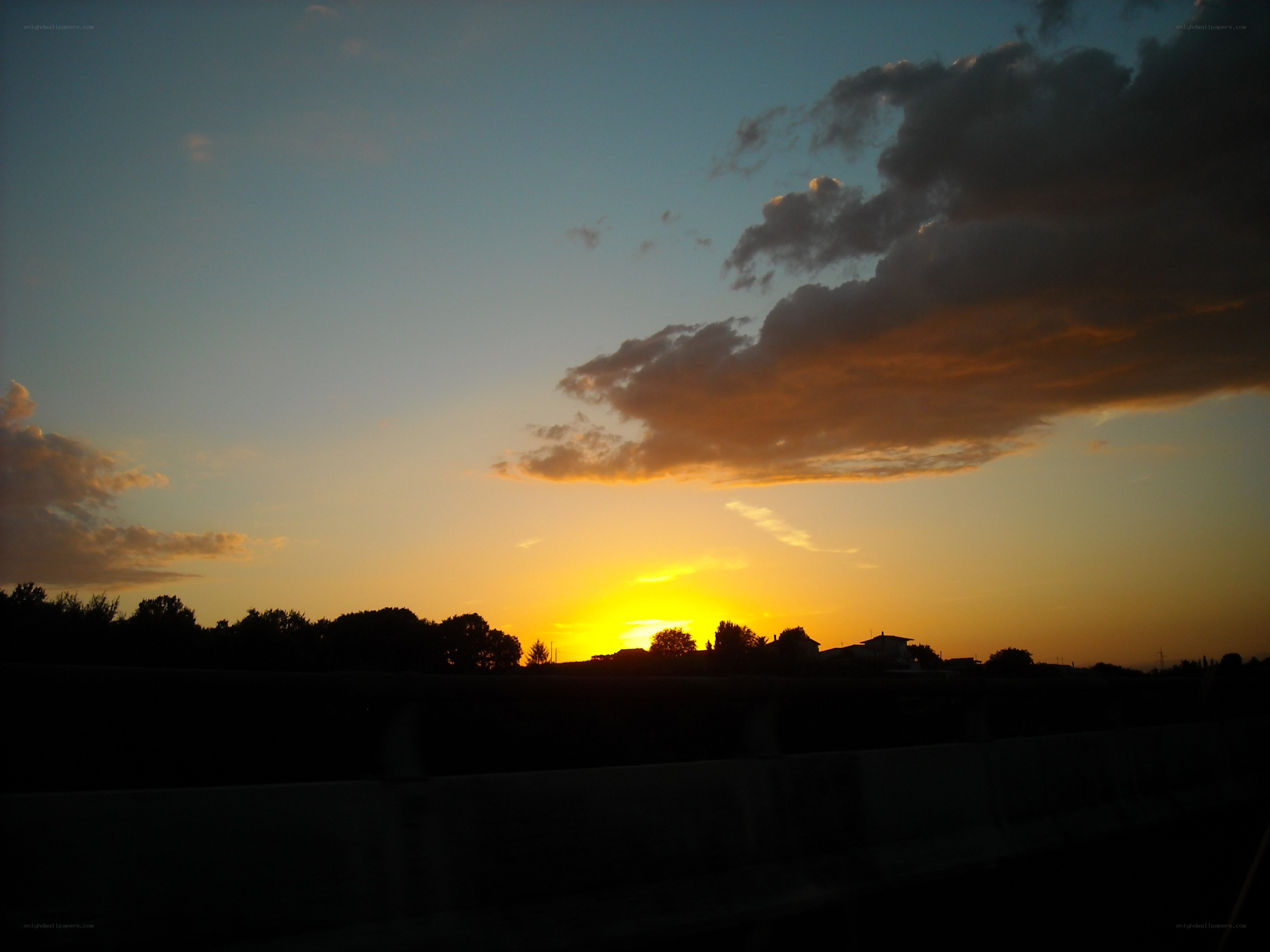 sunset over silhouetted landscape