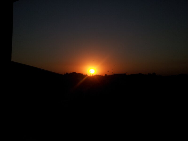 sunset over silhouetted landscape