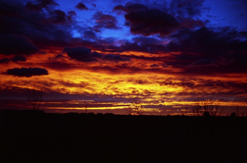 Sunset over Silhouetted Landscape — Blue