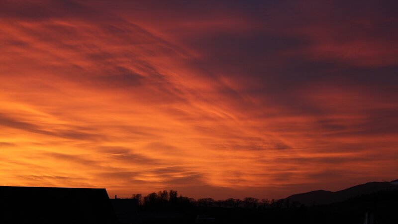 Sunset over Silhouetted Landscape — Orange, Dramatic, Photograph, Clouds, Mountains