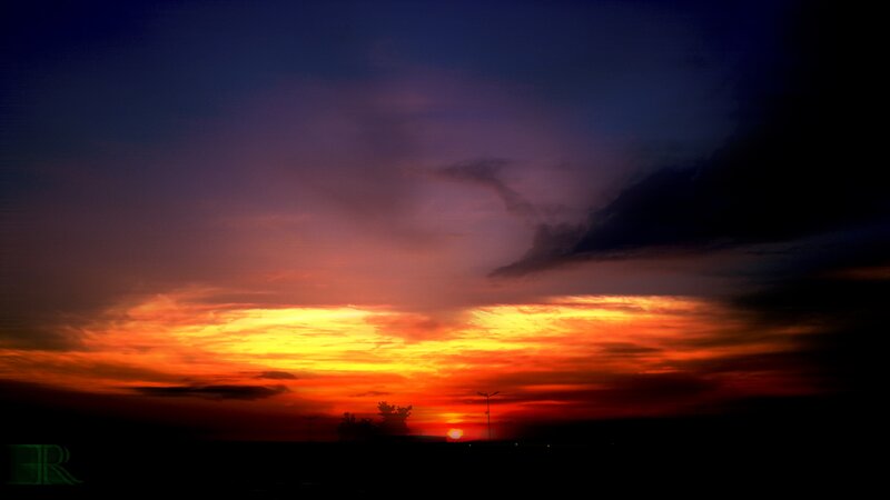 Sunset over Silhouetted Landscape — Orange, Dramatic, Photograph
