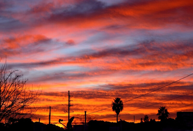 Sunset over Silhouetted Landscape — Orange
