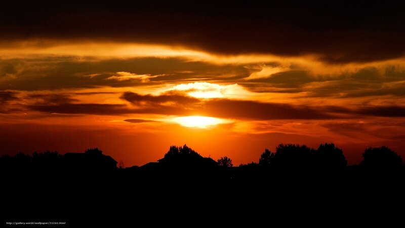 Sunset over silhouetted landscape