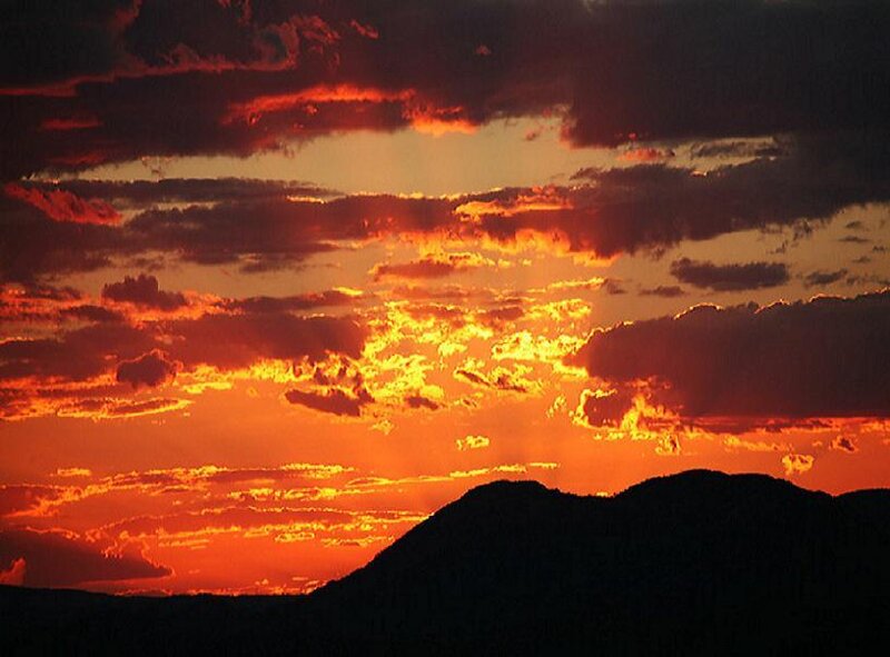 sunset over silhouetted mountains