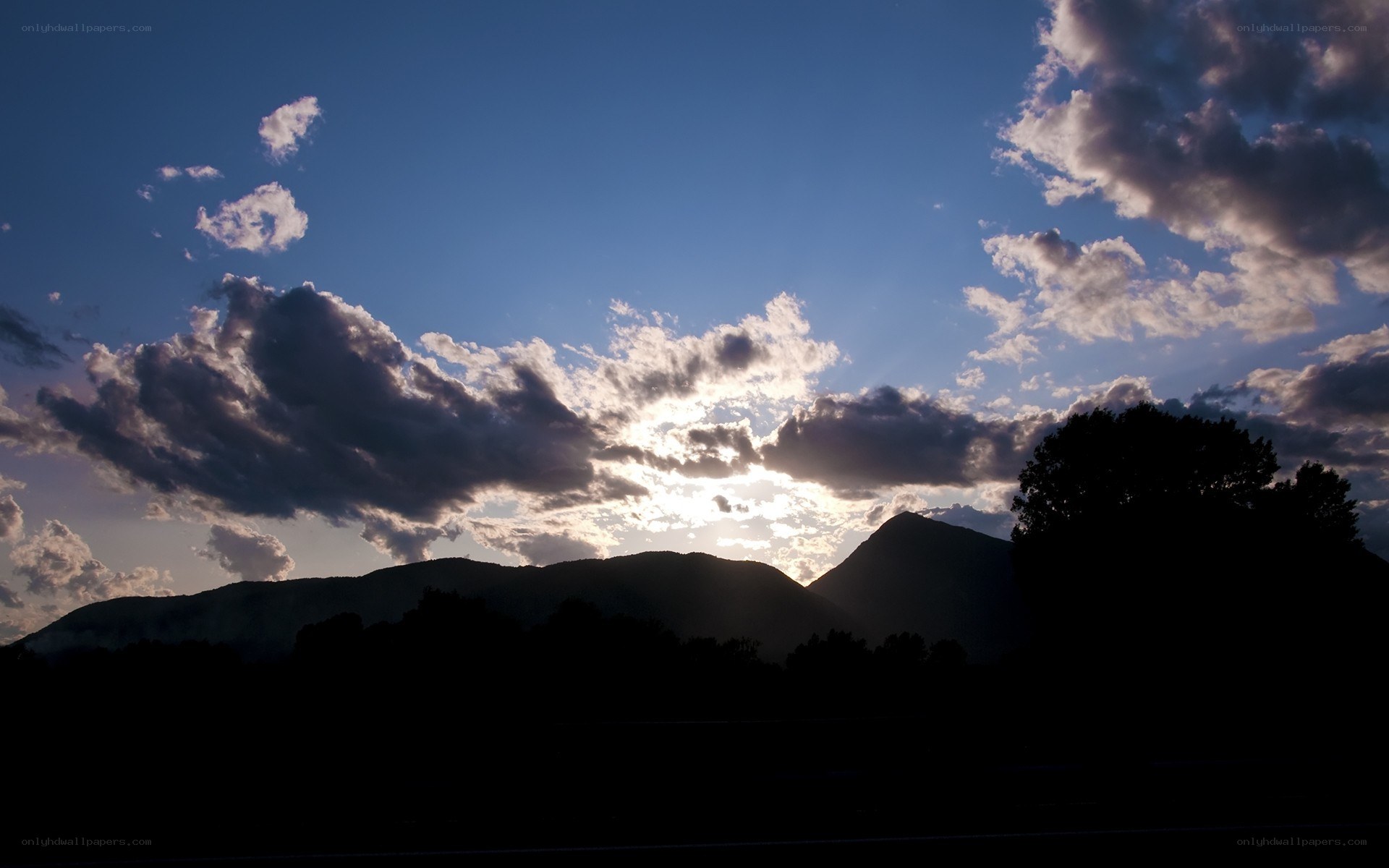 Sunset over silhouetted mountains