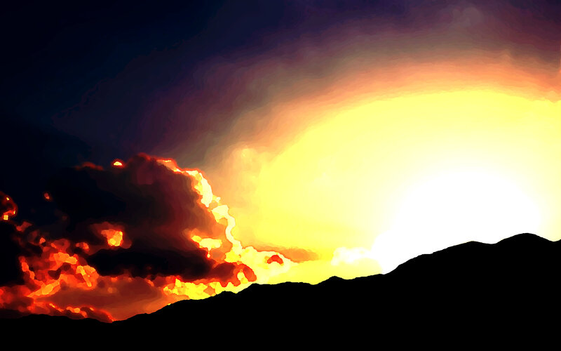 sunset over silhouetted mountains