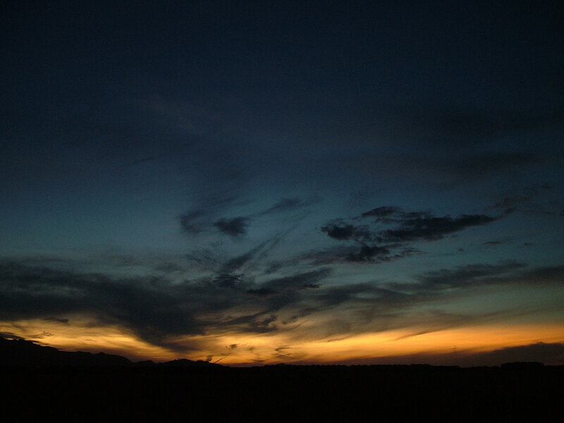 sunset over silhouetted mountains