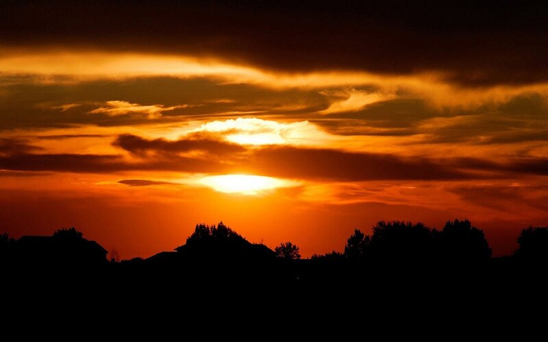 Sunset over Silhouetted Trees — Clouds