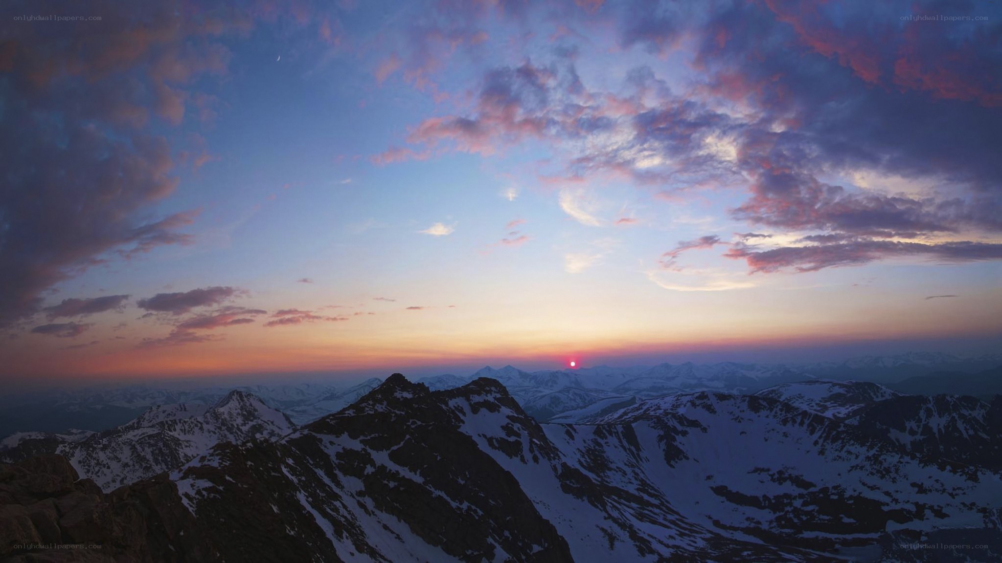 Sunset over snow-capped mountains