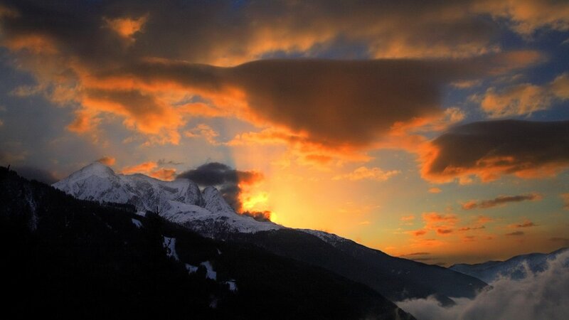 sunset over snow-capped mountains