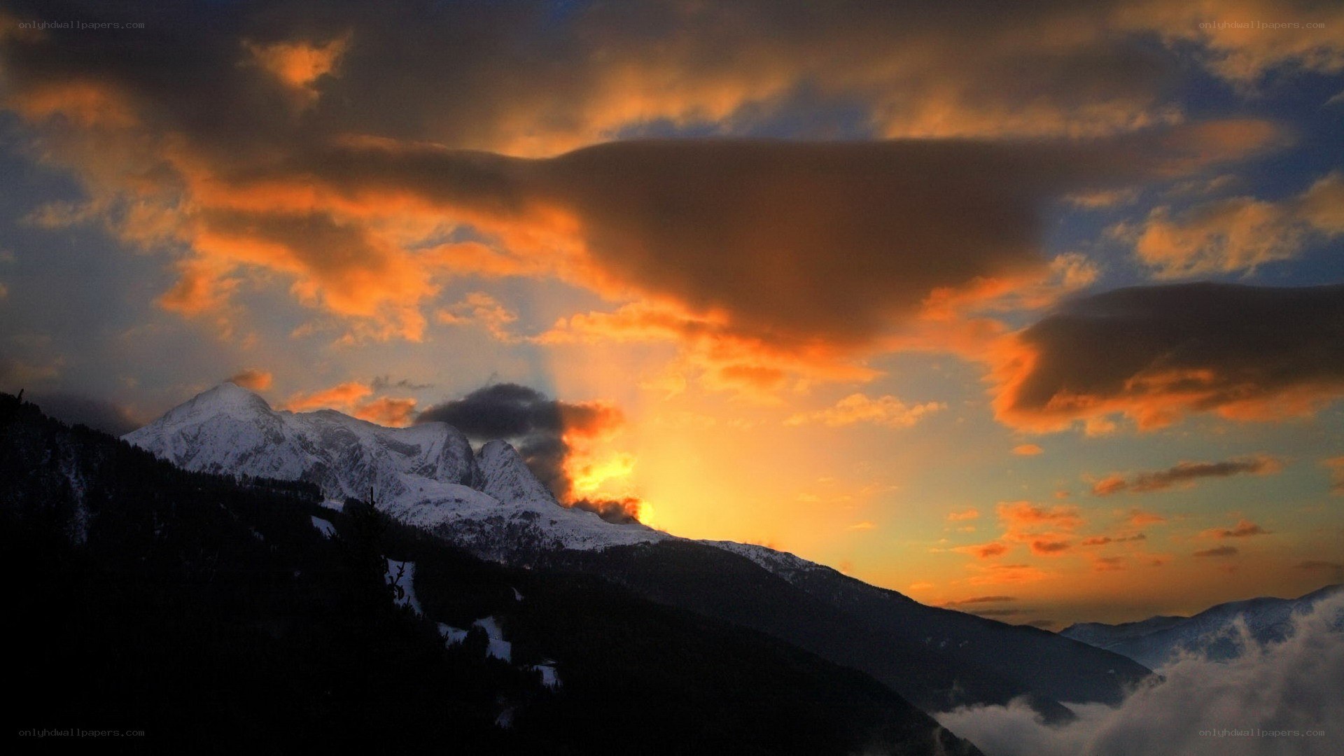 sunset over snow-capped mountains