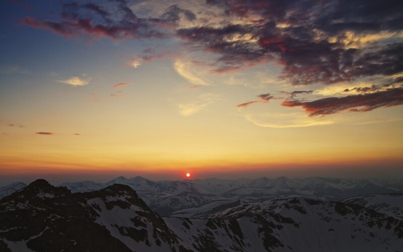 Sunset over snow-capped mountains