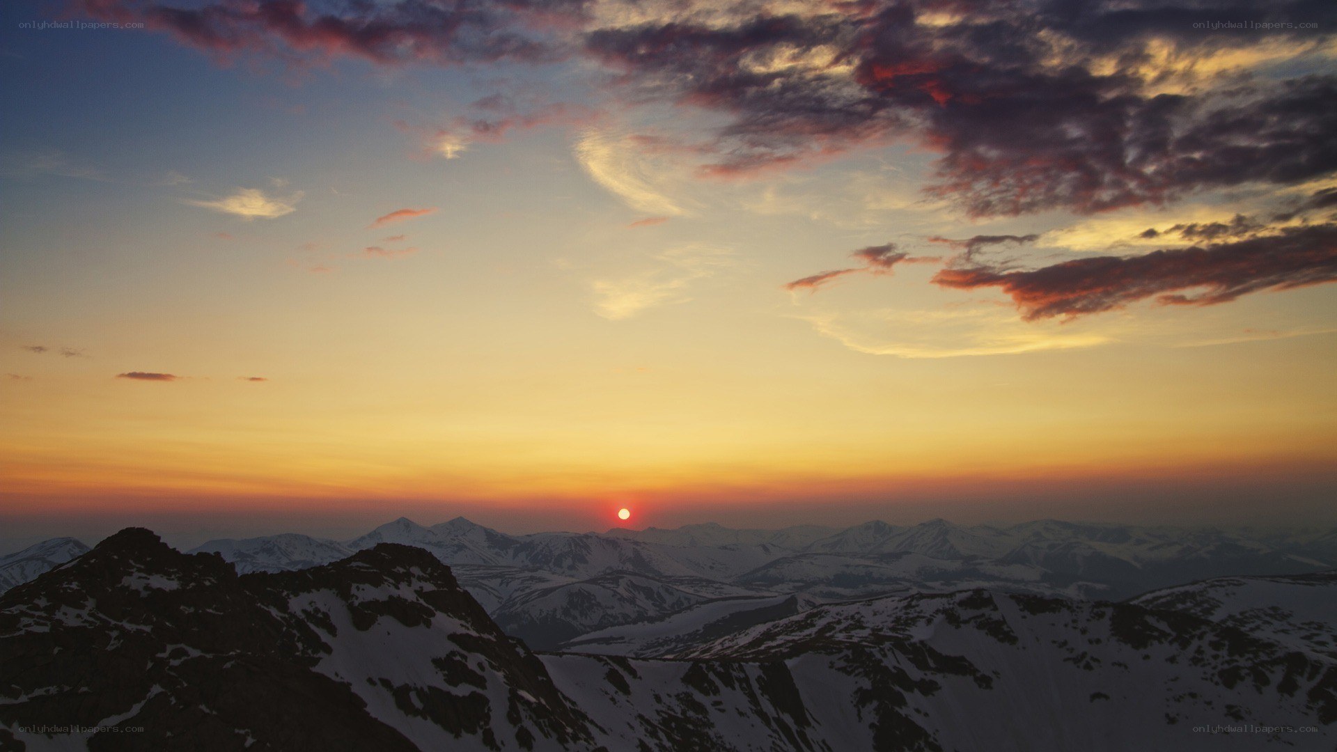 Sunset over snow-capped mountains