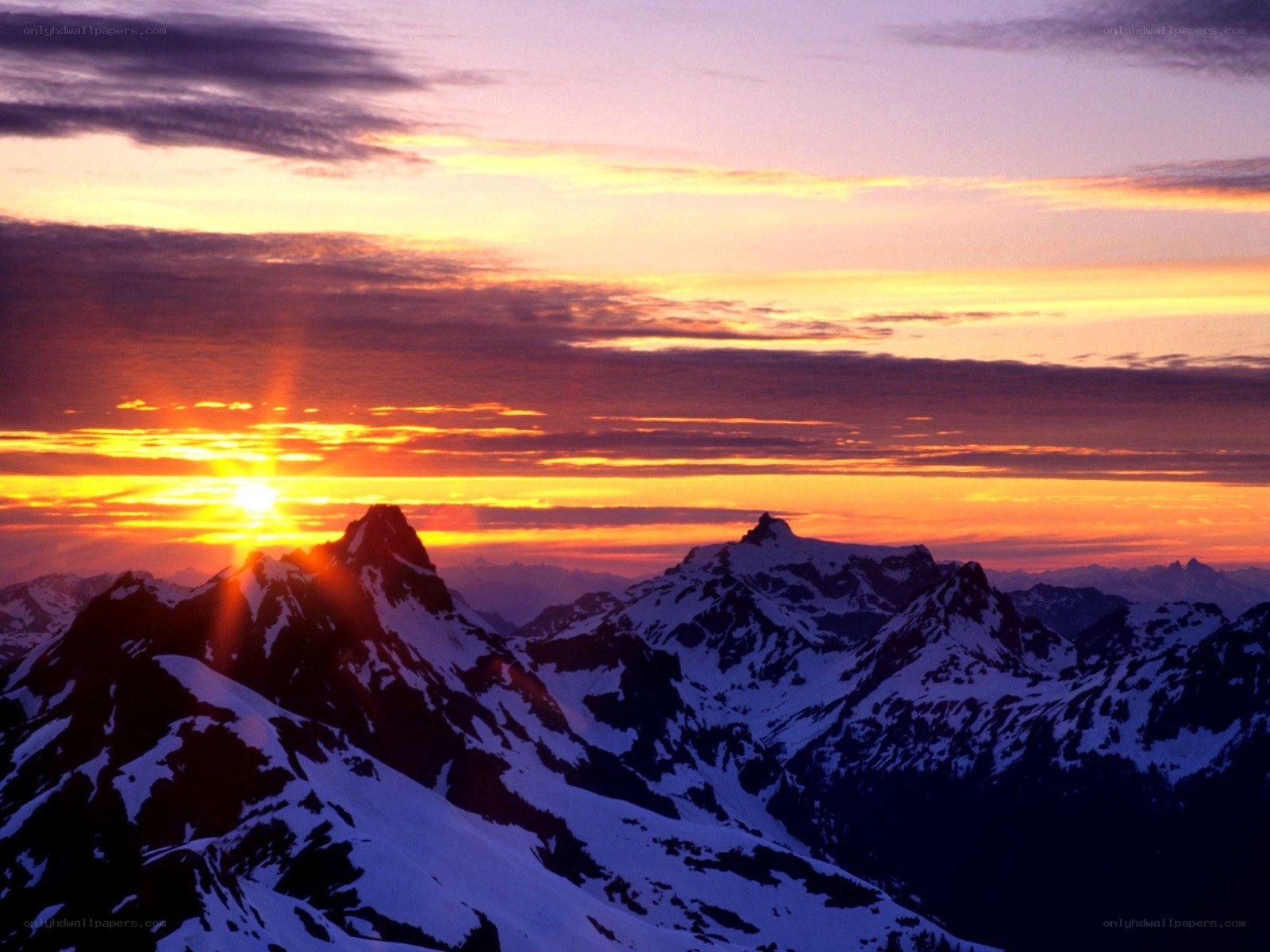Sunset over snow-capped mountains
