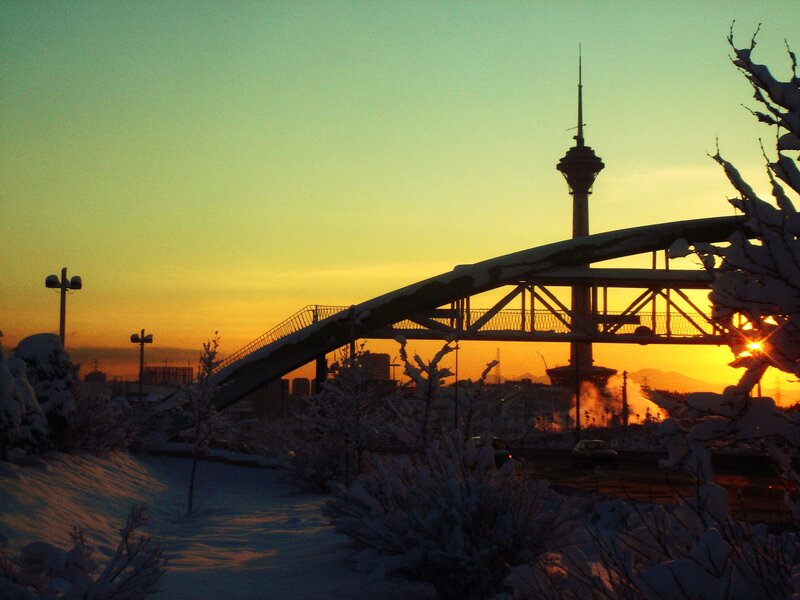 Sunset over snow-covered city