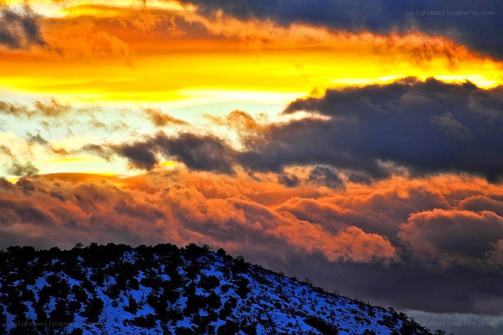 Sunset over snow-covered hills
