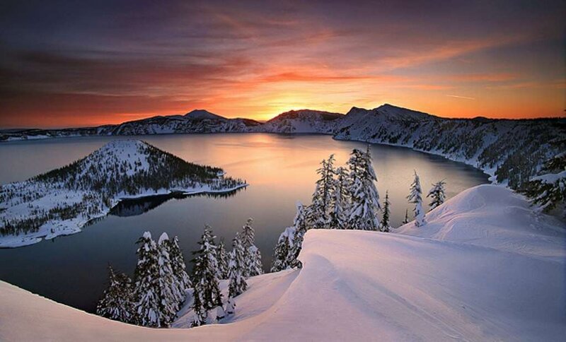 sunset over snow-covered lake