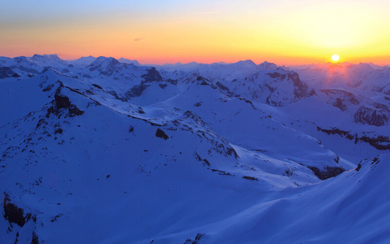 Sunset over snow-covered mountains