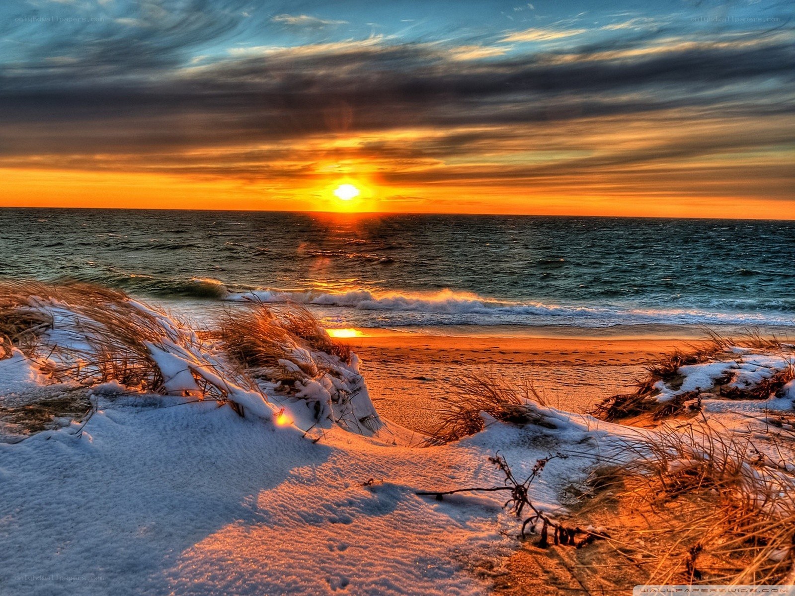 Sunset over snowy beach