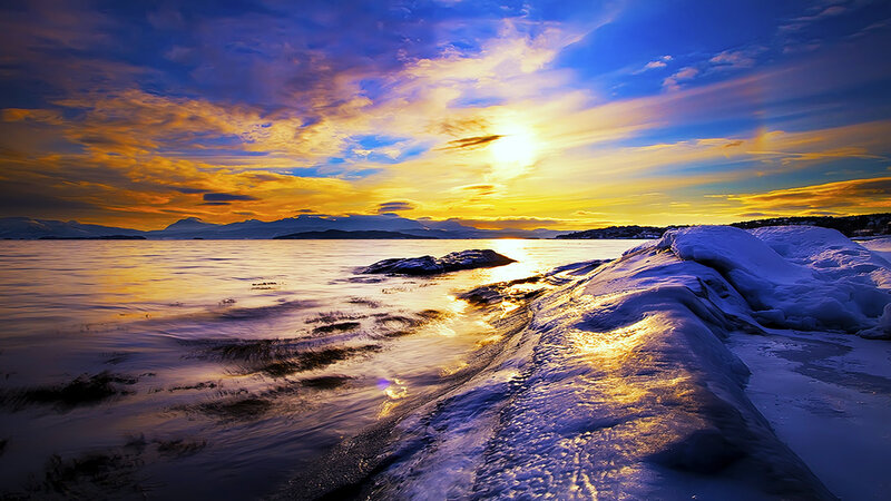 Sunset over snowy coast
