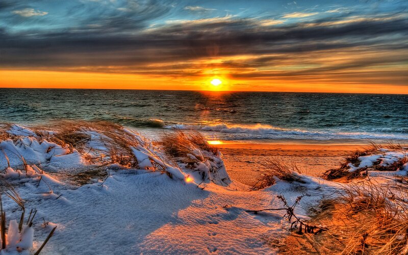 Sunset over snowy dunes