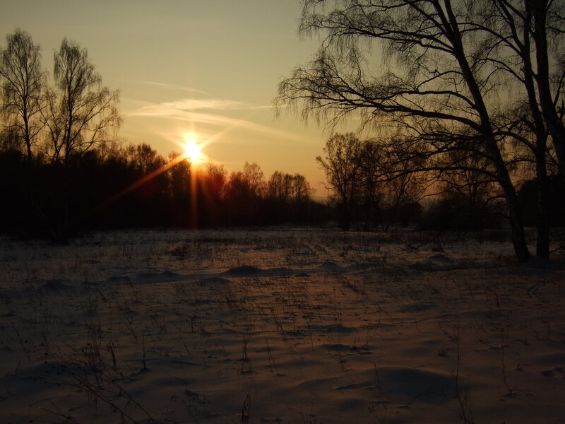 Sunset over snowy field