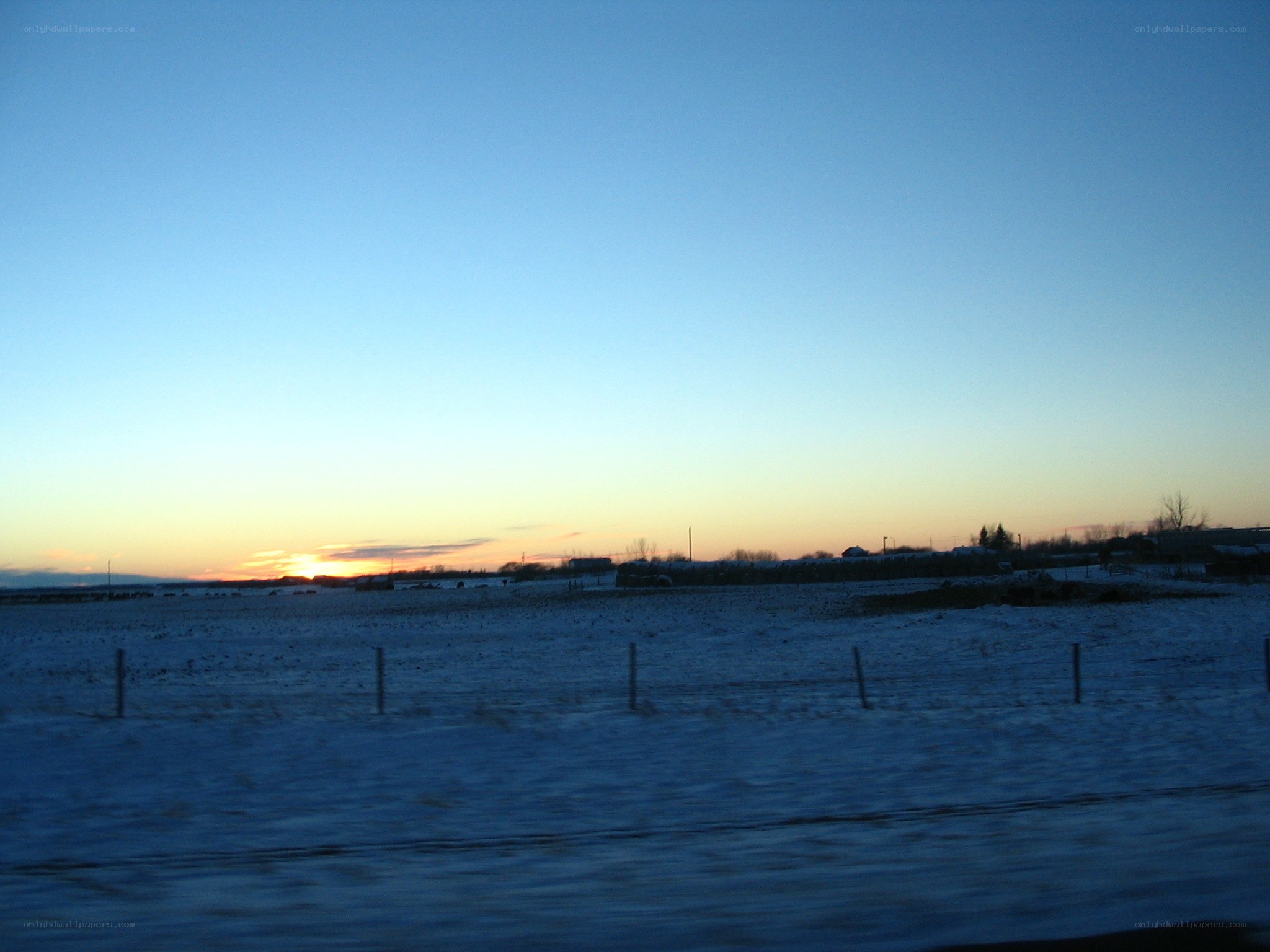 sunset over snowy field