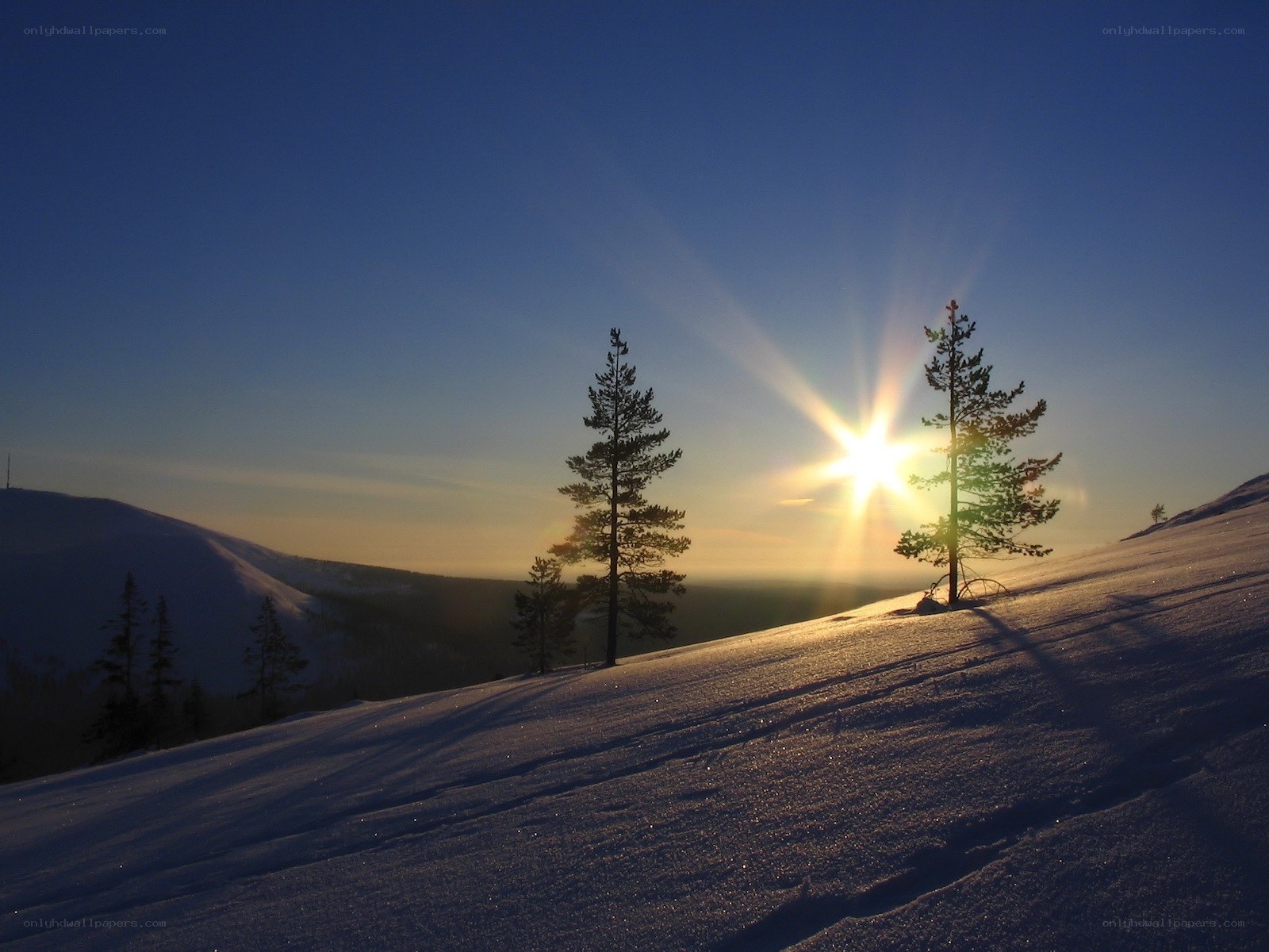 Sunset over snowy hills