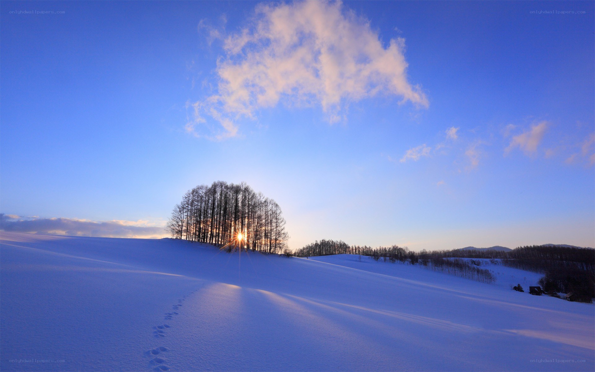 Sunset over snowy hills