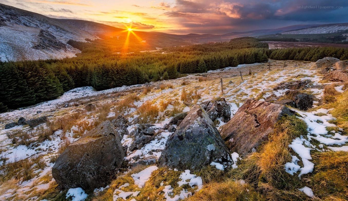 Sunset over snowy hills