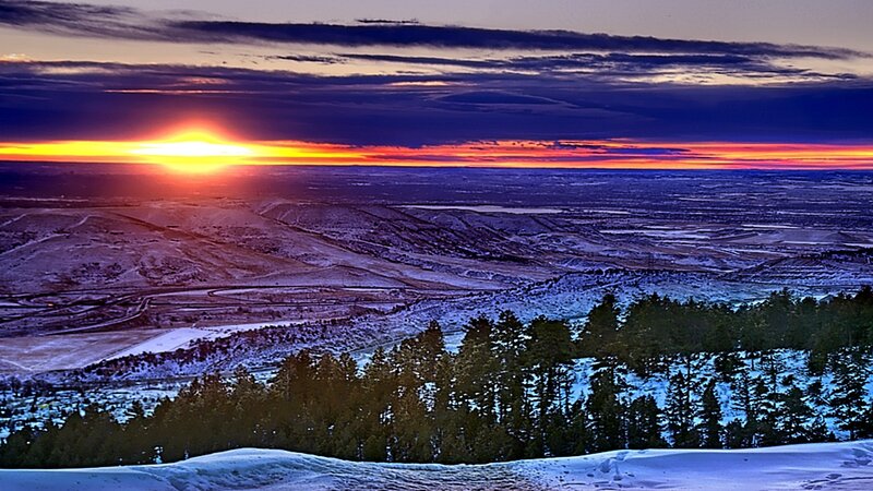 Sunset over snowy hills