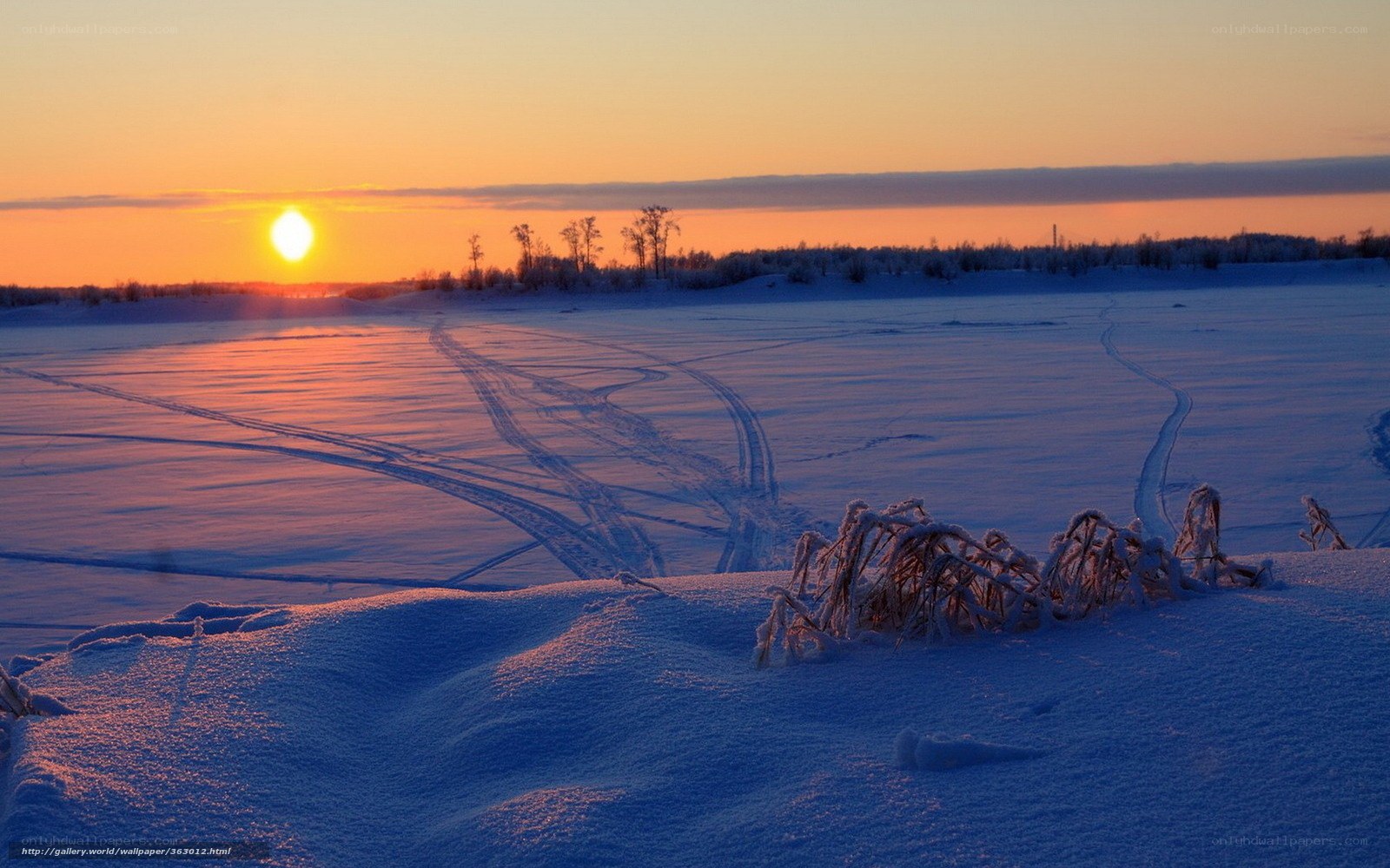 sunset over snowy landscape