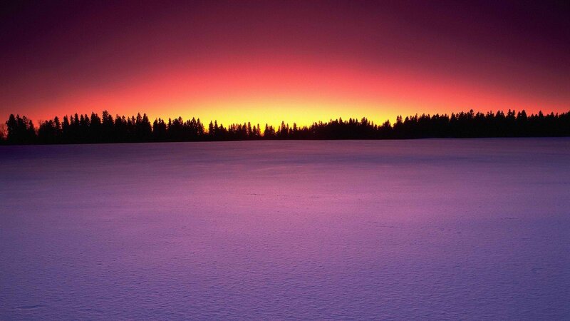 sunset over snowy landscape
